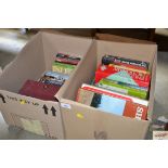 Two boxes containing books and DVDs