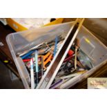 A box of miscellaneous pens, rulers, letter opener