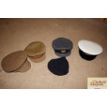 A box containing military hats including navy, RAF
