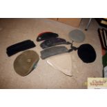 A box containing various military hats, some WW2