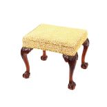 A George III style mahogany dressing stool, the upholstered top raised on bold carved cabriole