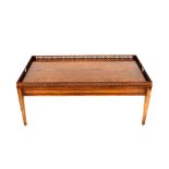 A good quality chestnut coffee table, with pierced galleried top raised on square section tapering
