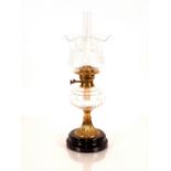 A Victorian oil lamp, having brass column and cut glass reservoir, etched shade and chimney, 60cm