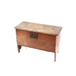 An 18th Century oak coffer, of small proportions, the square iron lock plate raised on shaped end