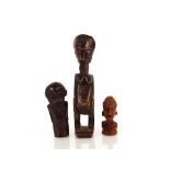 An Ethnographic naively carved figure of a woman, 25cm high; a small Oceanic wooden bust crouched