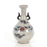 A Chinese blue grey and red decorated pottery vase, of baluster form with floral and fish