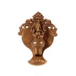 A late 19th Century Indian bronze wall oil lamp, with dragon mask and seated Ganesh having