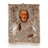 A 19th Century hand painted Orthodox icon, with a tooled silver cover, various stamps including .
