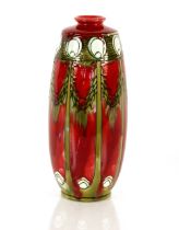 A Minton Secessionist pottery vase, with a red ground body and piped stylised flowers, printed