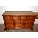 A good quality oak dresser base, fitted an arrangement of ten drawers within fluted columns,