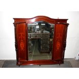 An Edwardian inlaid mahogany overmantel mirror, the central bevelled plate flanked by panels