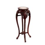 A Chinese carved hardwood plant stand, having pierced foliate decoration, the circular top with