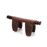 A 19th Century African Zulu carved hard wood head rest, with a single piece top, raised on four
