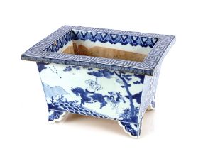 A large 19th Century Oriental blue and white rectangular cache pot, decorated with figures,