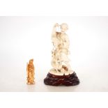 A Japanese carved ivory figure of a street vendor,