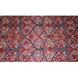 A rug or throw, with Art Nouveau influences, the ivory field with stylised foliage within an