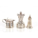 A silver pepper mill, London 1890; a small silver pepperette Chester 1912; a silver drum shaped