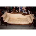 A 19th Century mahogany scroll end couch, raised on turned fluted supports terminating on brass