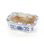 A small 19th Century Chinese blue and white rectangular cache pot, having stylised floral motifs and