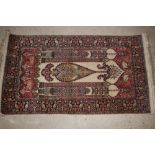 An Indian silk rug, with all over floral decoration and central motifs, 133cm x 34cm