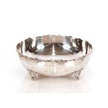 A George V silver bowl, having foliate cast border raised on scrolled feet, Birmingham 1929, 22.5 cm