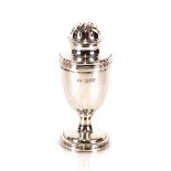 A silver baluster pepperette, with reeded decoration, London 1914, 10cm high
