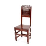 An 18th Century oak joined chair, having panelled back, solid seat raised on square section turned