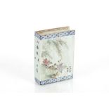 A Chinese porcelain book shaped plaque, decorated birds and foliage with calligraphy and symbols,