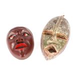 An African polychrome painted mask, 20cm high; together with another painted African mask, 31cm high