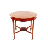 An Edwardian mahogany and satinwood strung centre table, the shaped top raised on square tapering