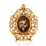 A pair of 20th Century gilt metal Rococo frames, each centred with a painted still life panel of