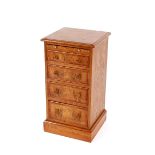 A pair of burr oak and cross banded bedside chests, fitted pull out slides and four graduated