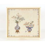 A Chinese watercolour on silk, depicting flowers in antique vases within a foliate border, 37cm x
