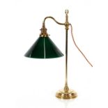 A brass adjustable desk lamp, with green glass shade, 56cm high