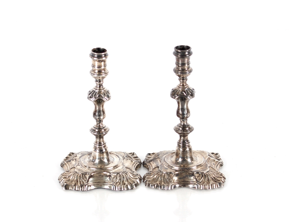 A pair of early 20th Century cast silver taper sticks, in the 18th Century style, Hallmarked for