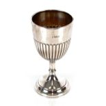 A George V silver goblet, having half fluted body decoration raised on a knop stem and circular