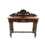 A Victorian carved oak hall table, having raised back piece with pierced foliate and mask decoration