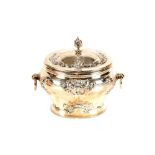 An Edwardian silver tea caddy, having foliate embossed decoration, the hinged lid with foliate