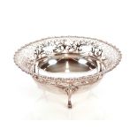 An Edwardian silver fruit bowl, having pierced foliate border raised on three pad feet, London 1909,