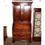 A George III mahogany bureau bookcase, the upper section fitted interior shelves, pigeon holes and