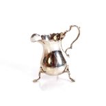 A mid-20th Century silver baluster cream jug, of George II design, having serrated border,