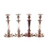 A set of four Victorian plate on copper candlesticks, having gadrooned border decoration, 30cm high