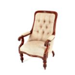 A Victorian mahogany framed armchair, buttoned grey upholstery with scrolled arms above turned