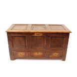 A 18th Century oak mule chest, with fielded panel front above three base drawers, 130cm wide