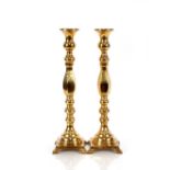A pair of brass candlestick shaped lamp bases, of baluster form raised on square plinths and bracket