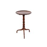 A 19th Century circular mahogany tilt top occasional table, raised on turned baluster column and