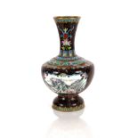 A Cloisonné baluster vase, decorated with panels of flowers, birds and mountain scenes, all over