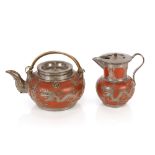A late 19th / early 20th Century Yixing teapot, and lidded jug encased with finely worked pewter (