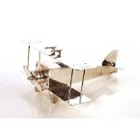 A 20th Century plated ink well, in the form of a bi-plane, stamped Franz Reichenberg, Berlin, 40