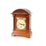 A late Victorian oak cased bracket clock, with brass spandrel dial and silvered chapter ring,